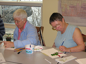 Two women painting