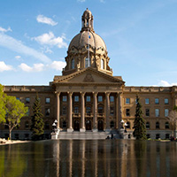 Image of the Alberta legislature building with a water feature in front